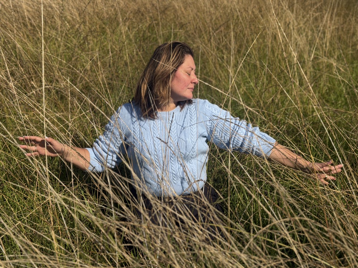 Jessica in a light blue jumper in a grassy field