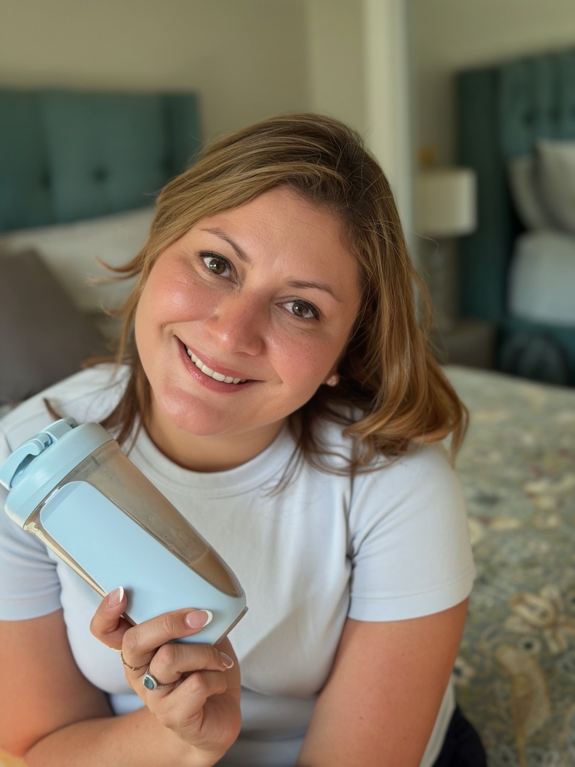 Jessica at home holding a shaker bottle