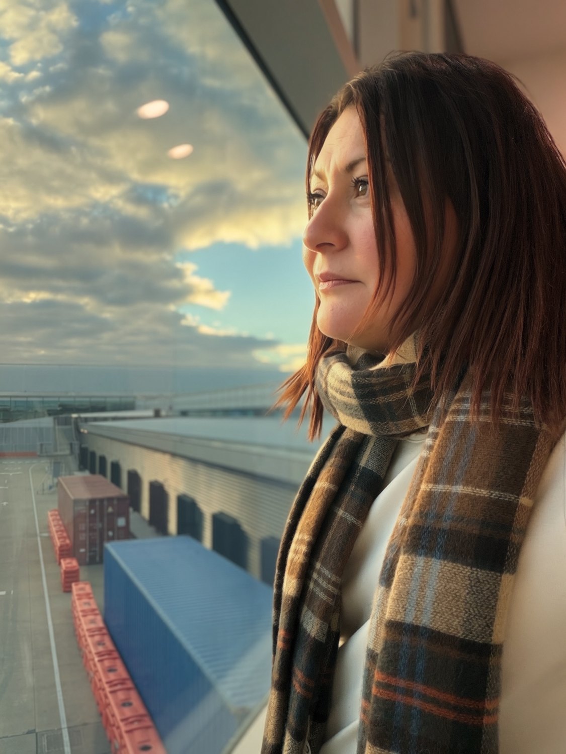 Jessica looking out a window at the airport