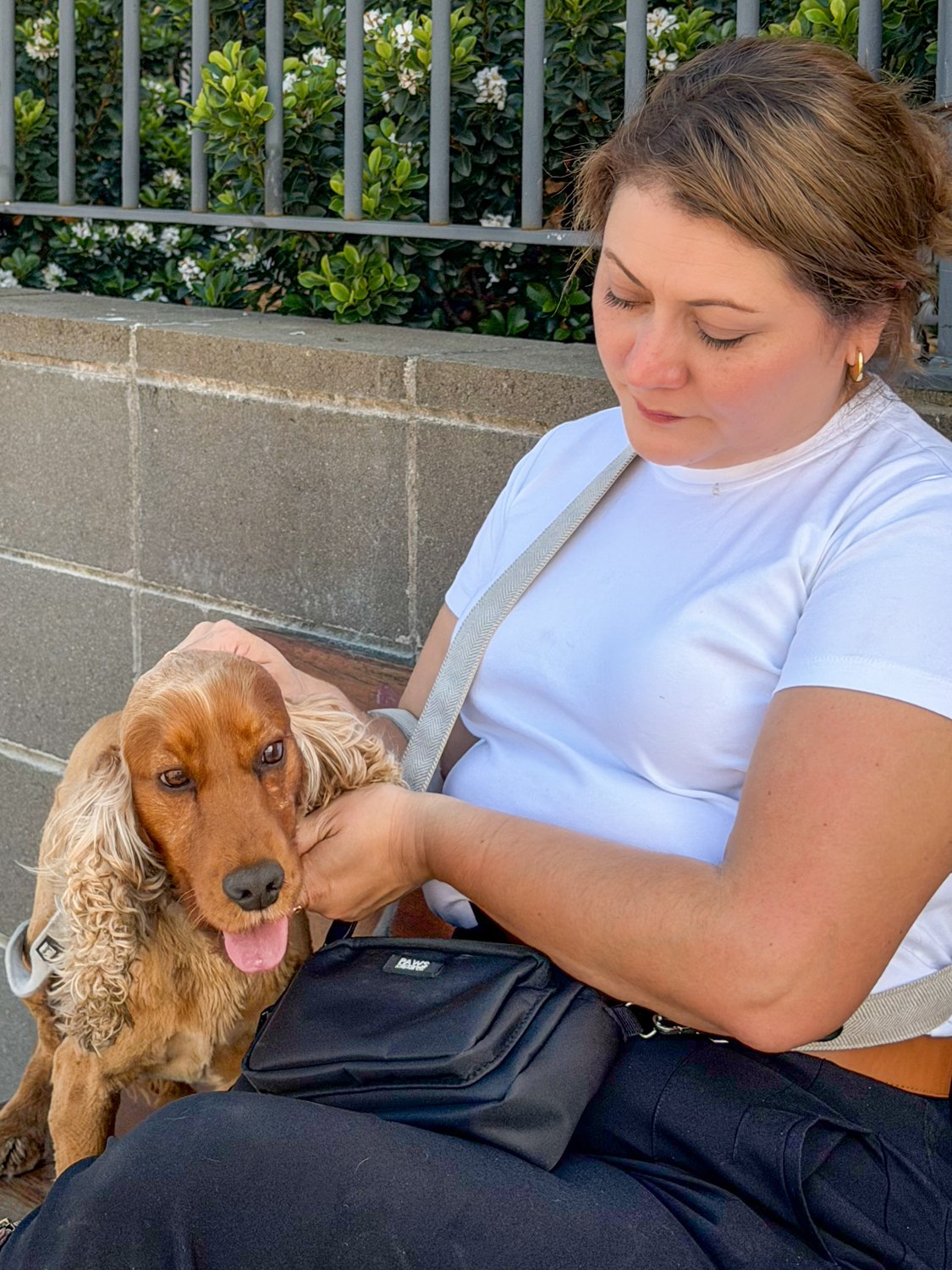 Jessica sitting with a spaniel
