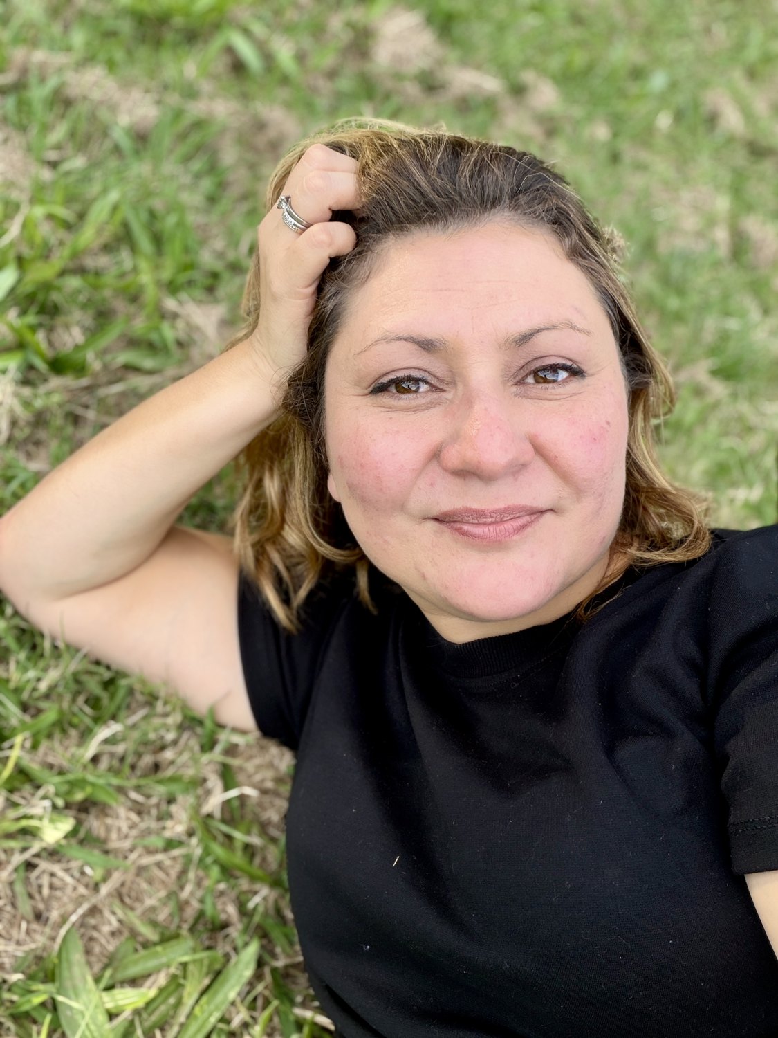 Jessica lying on the grass, relaxed and natural