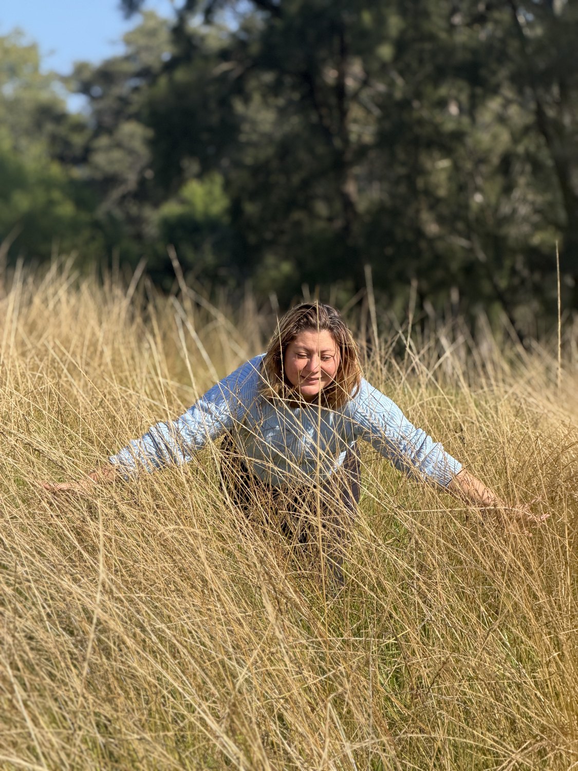 Jessica walking through tall grass