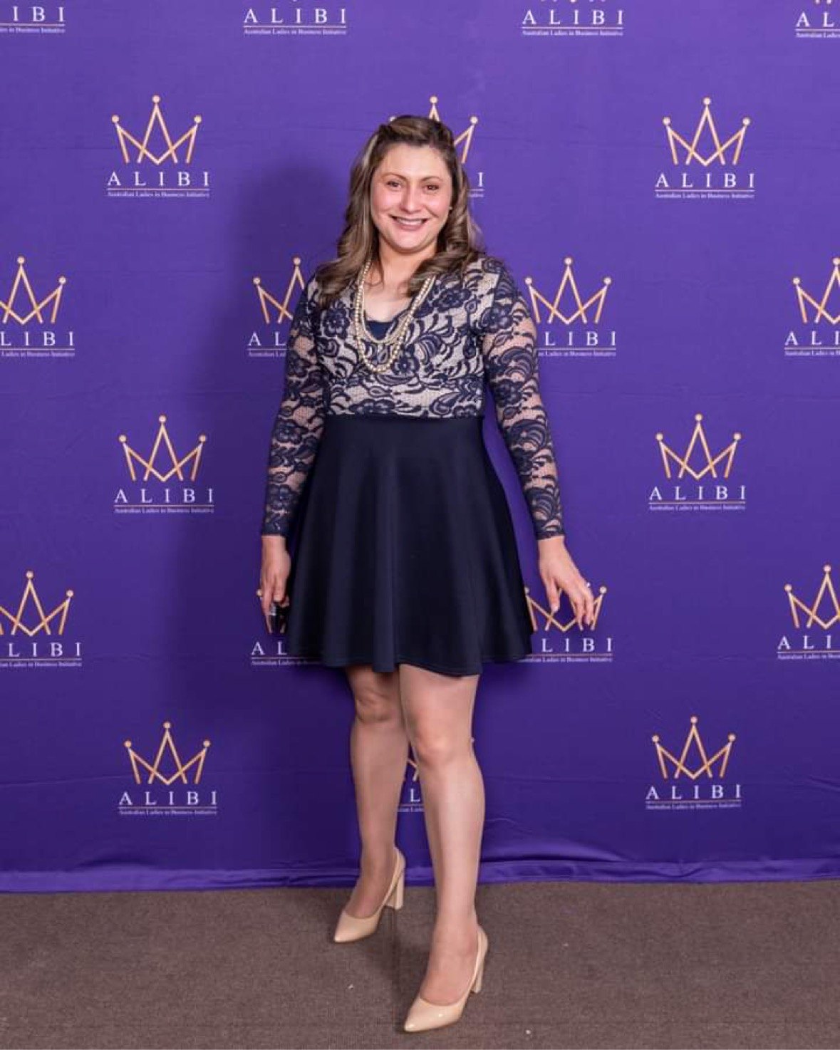 Jessica at a business event in a navy lace dress